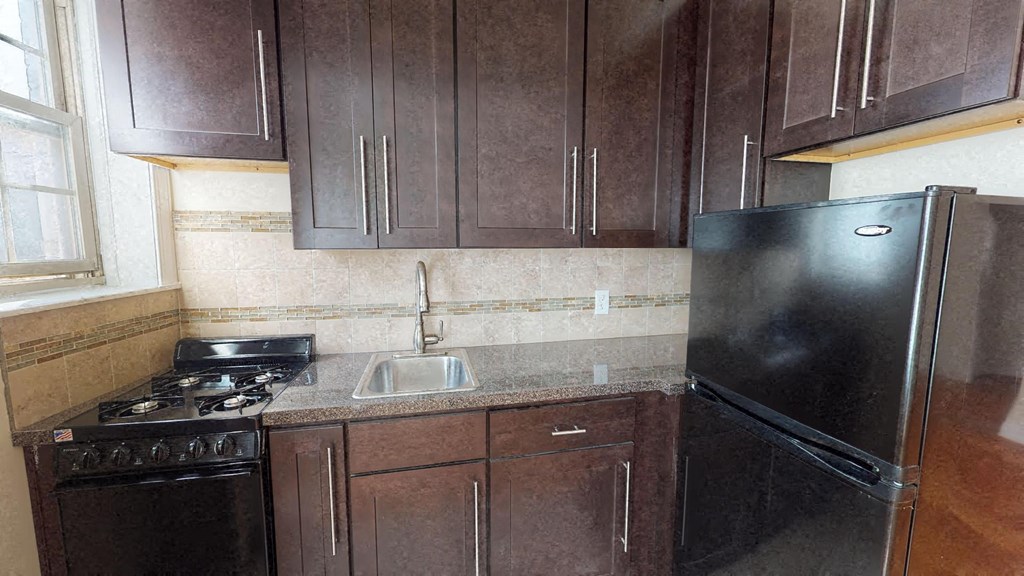 a small kitchen with a stove and a refrigerator