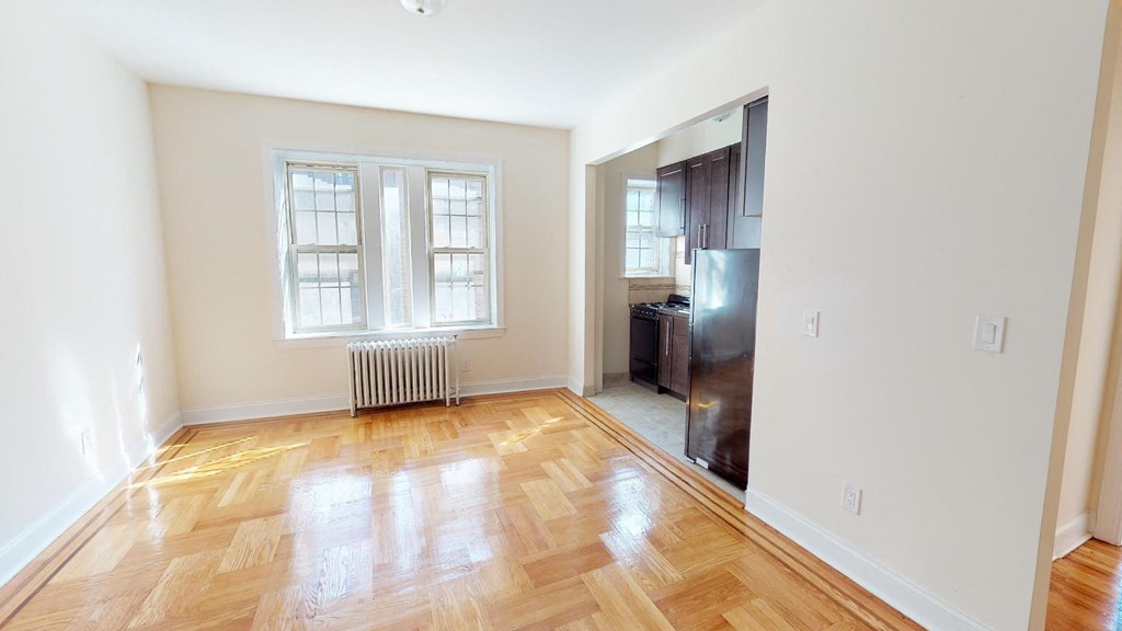 a living room with a hard wood floor and a window