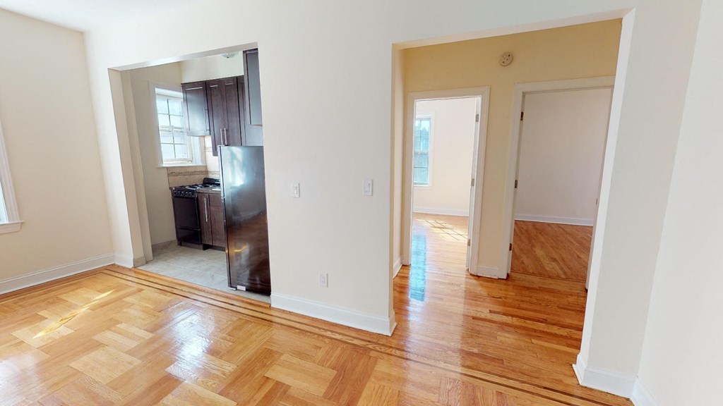 a renovated living room and kitchen with wood floors