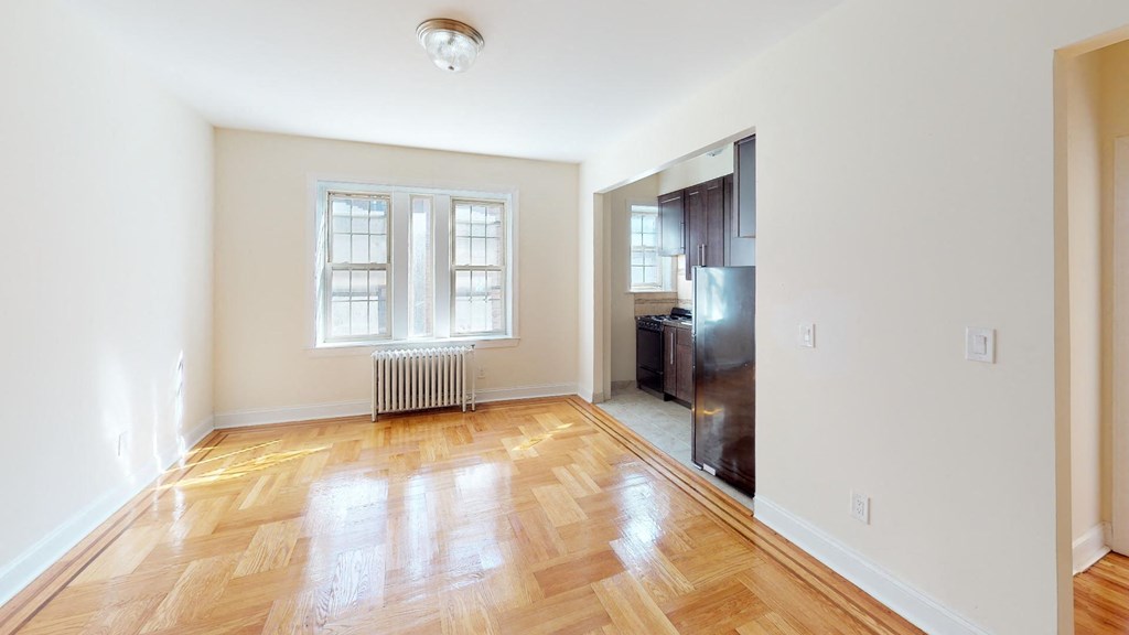 a living room with a wood floor and a window