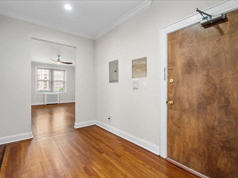 an empty room with a wooden floor and a door