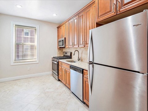 a kitchen with stainless steel appliances and wooden cabinets