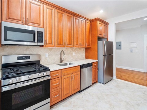 a kitchen with stainless steel appliances and wooden cabinets