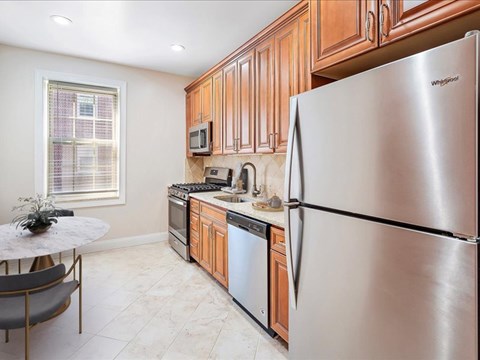 a kitchen with stainless steel appliances and wooden cabinets