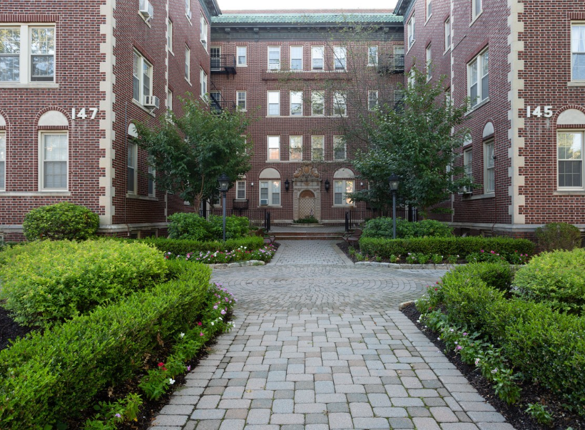 the courtyard in front of a brick building with a cobblestone walkway