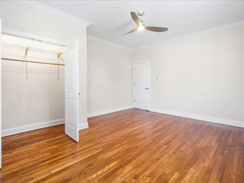 an empty room with a closet and a ceiling fan