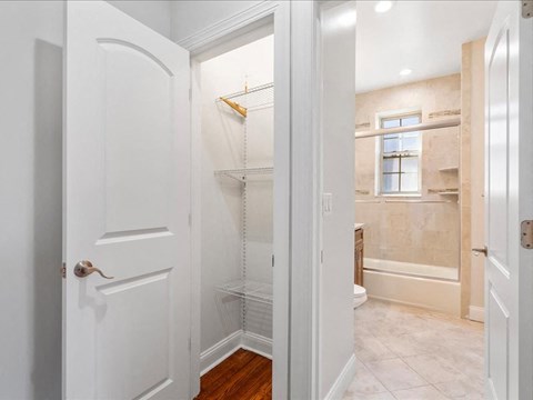 a white bathroom with a shower and a door