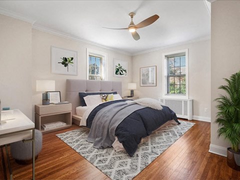 a bedroom with a bed and a ceiling fan