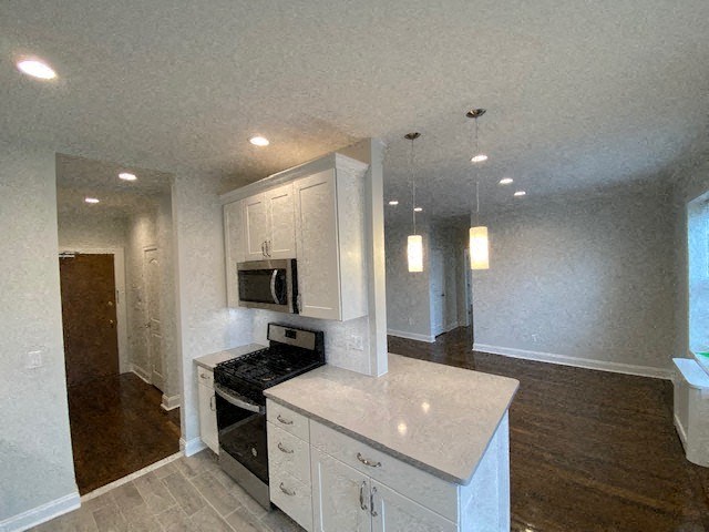 a white kitchen with a stove and a microwave