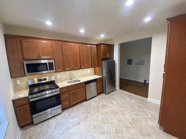 a kitchen with stainless steel appliances and wooden cabinets