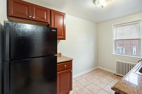 a kitchen with a refrigerator and a window