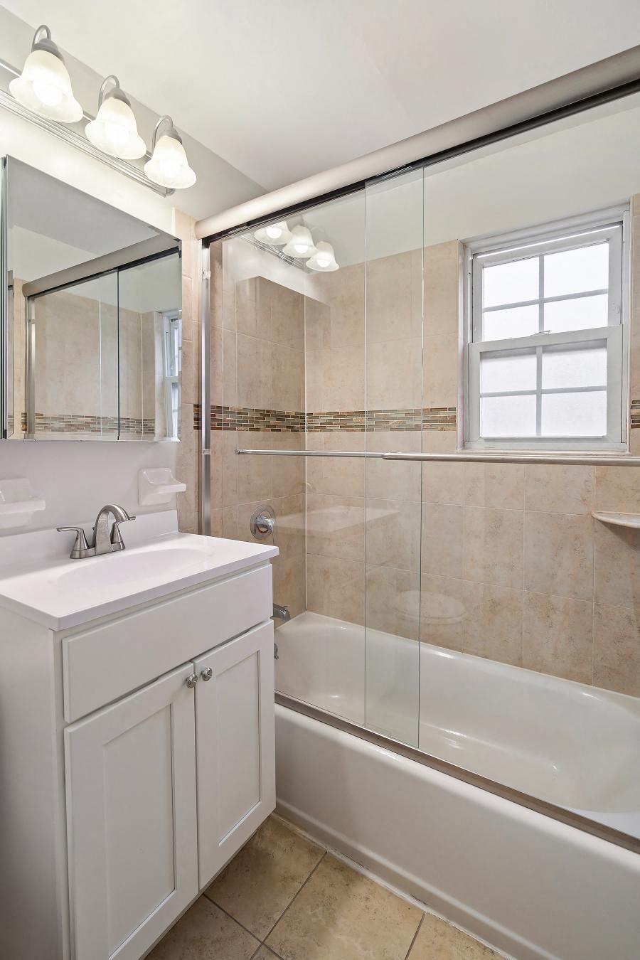 a bathroom with a sink and a shower and a bath tub