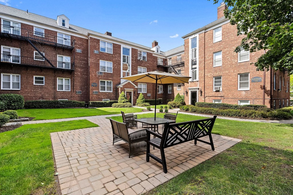 our apartments offer a patio with a table and chairs