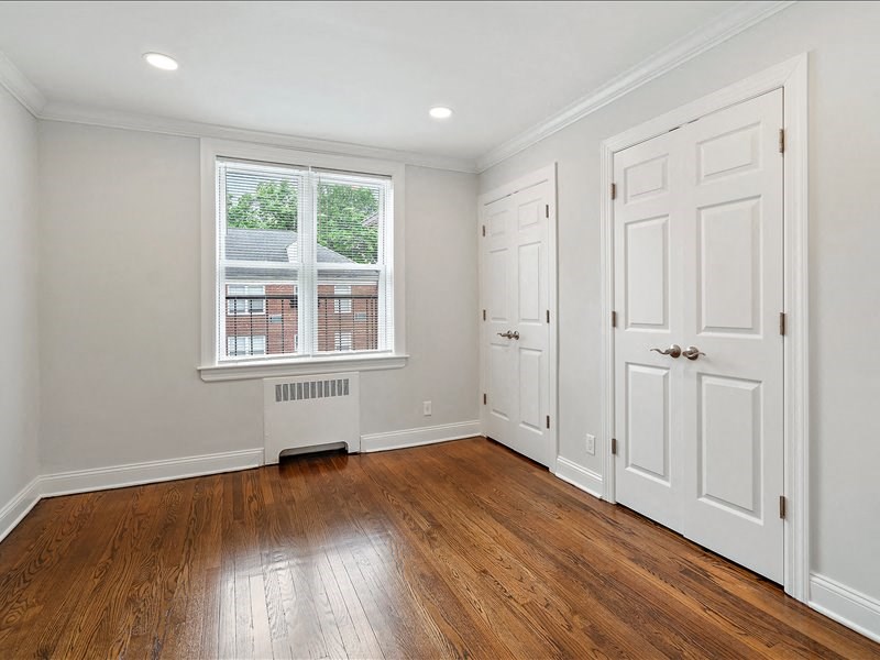 A room with a window and a radiator on the floor.