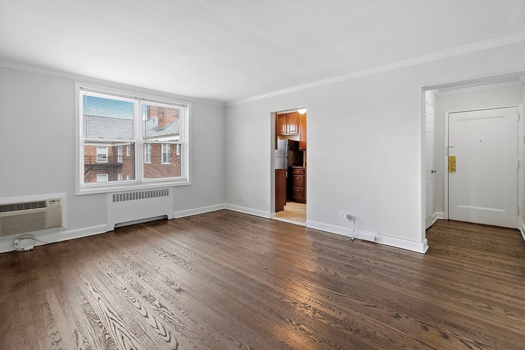 a living room with wood floors and white walls