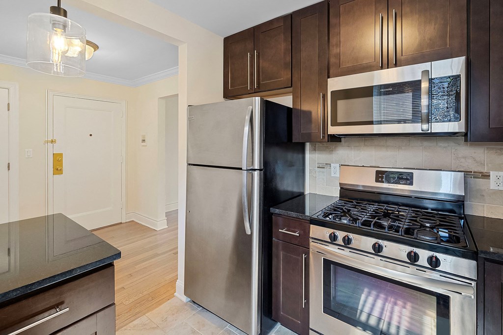 a kitchen with stainless steel appliances and wooden cabinets