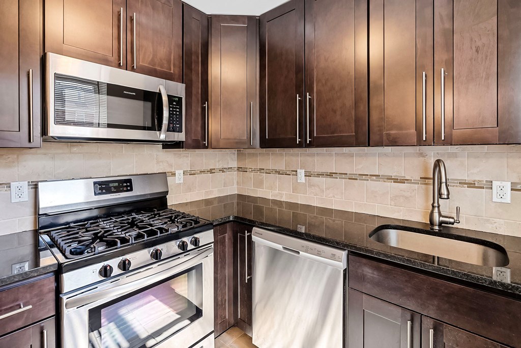 a kitchen with stainless steel appliances and wooden cabinets