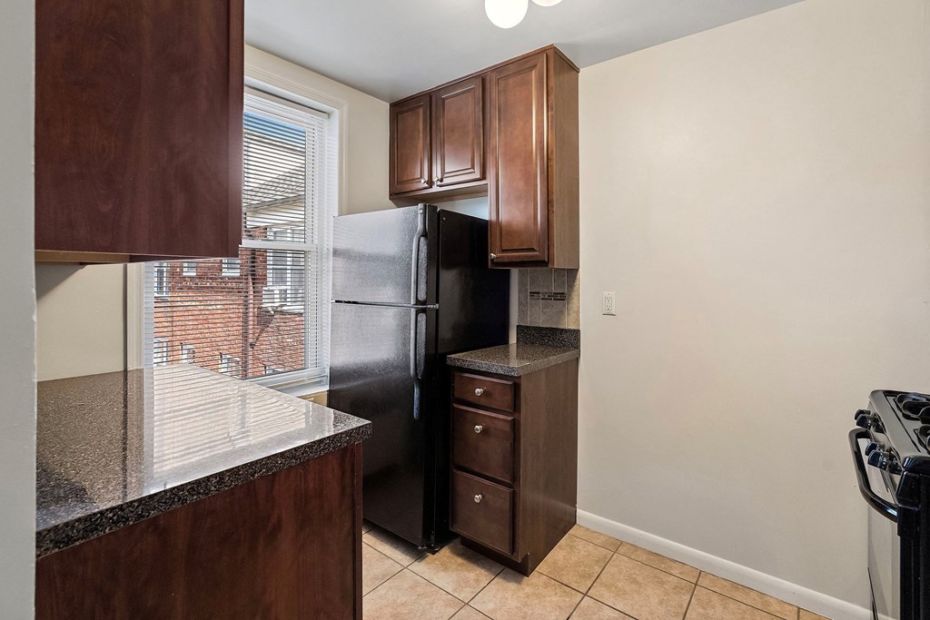 a kitchen with a refrigerator and a window