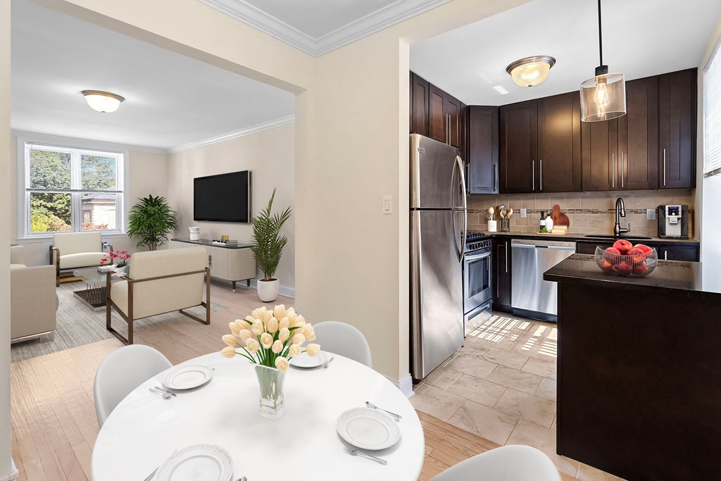 a kitchen and dining room with a white table and chairs