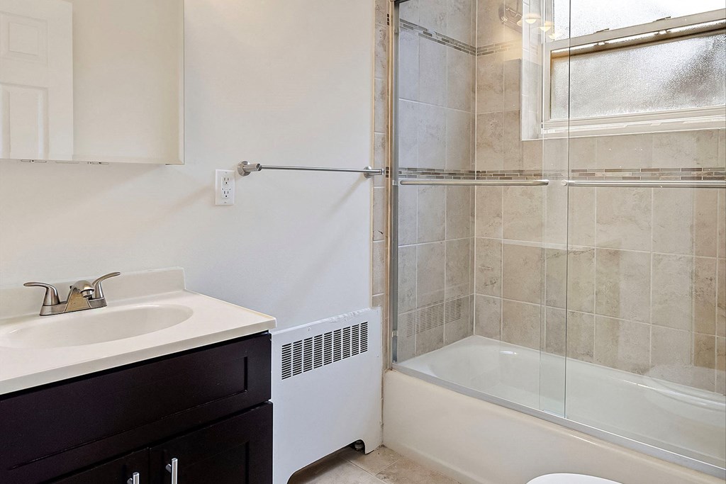 a bathroom with a sink and a shower and a toilet