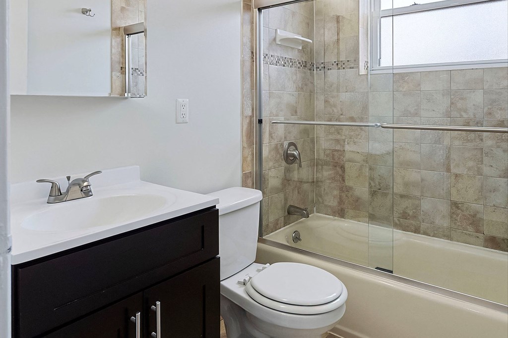 a bathroom with a sink toilet and shower