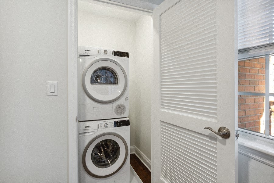 the laundry room has a washer and dryer and a window