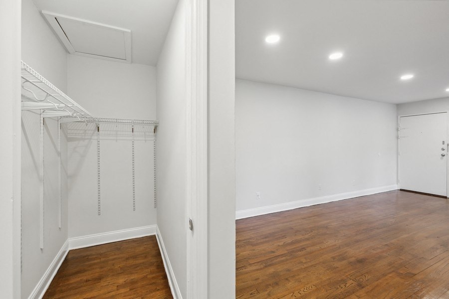 a room with a closet and a wood floor