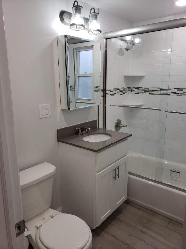 a bathroom with a sink toilet and a shower