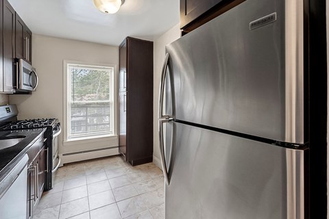 a kitchen with stainless steel appliances and a window