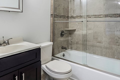 an image of a bathroom with a shower toilet and sink
