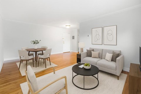 A living room with a couch, chairs, and a coffee table.