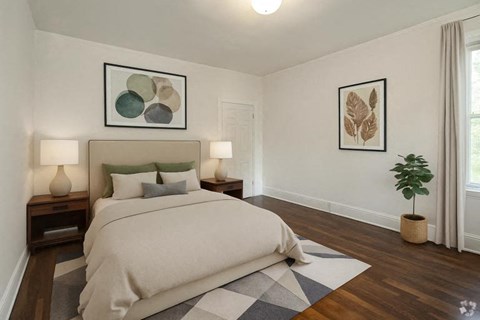 A bedroom with a large bed and two lamps on nightstands.