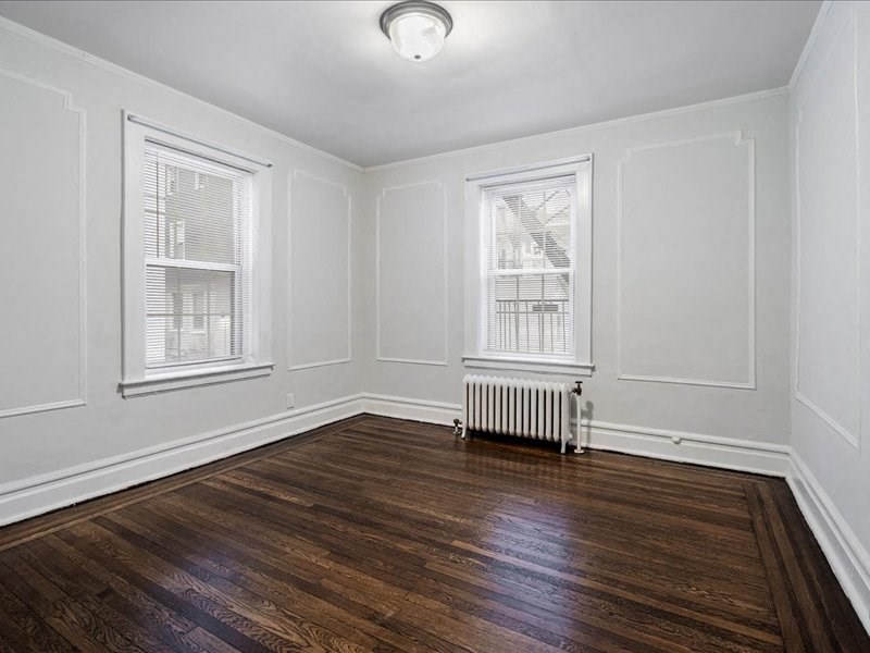 A room with wooden floors and white walls.