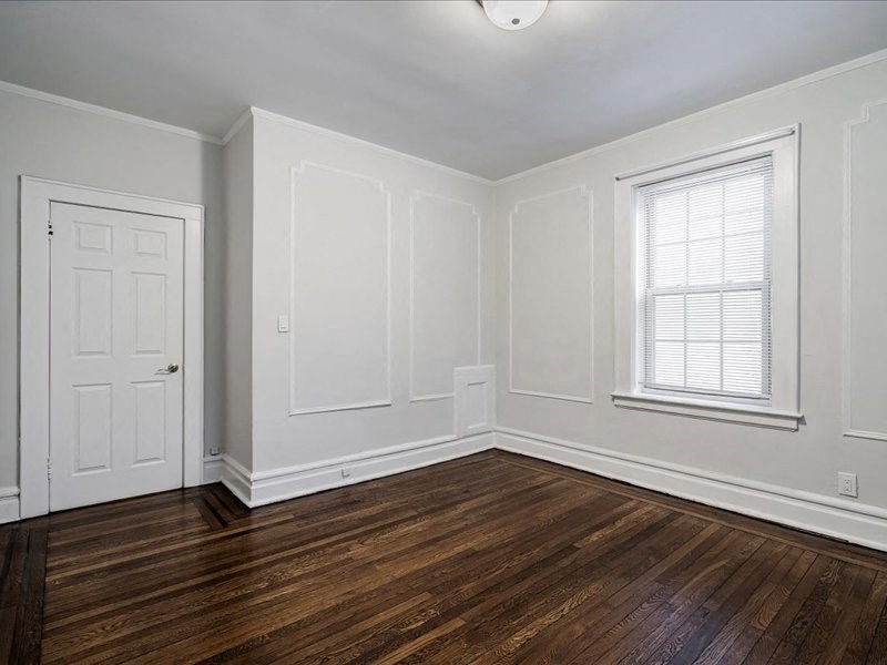 A room with a wooden floor and white walls.