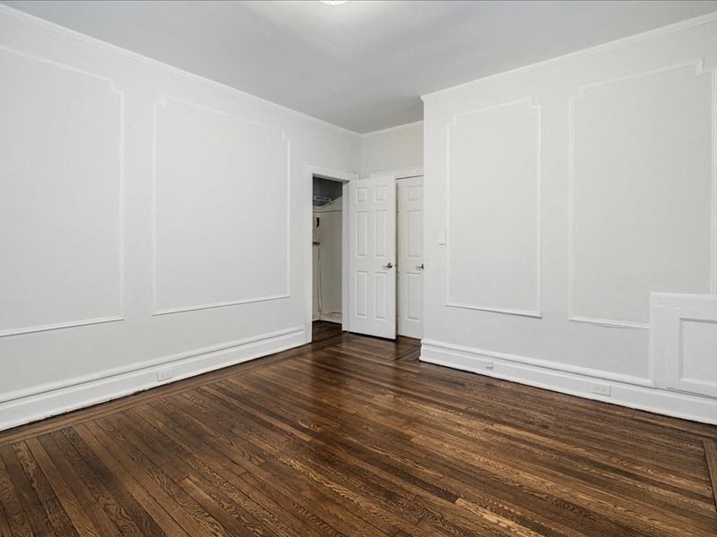 A room with white walls and wooden flooring.