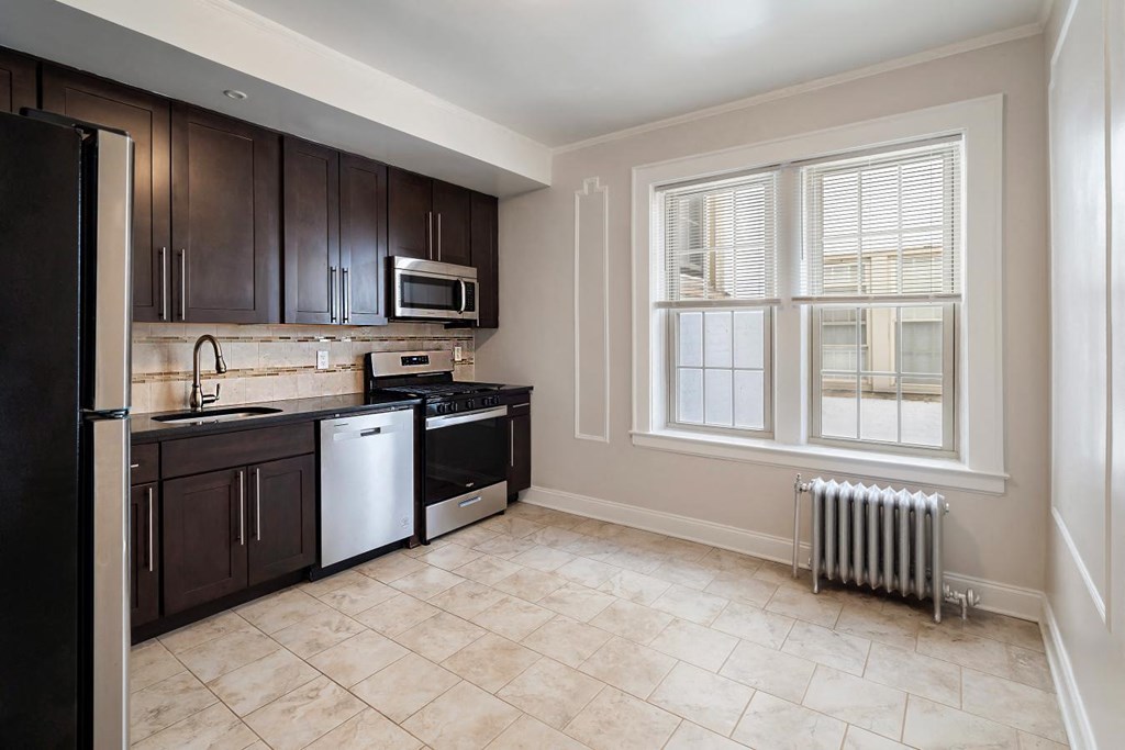 a kitchen with a stove top oven and a window