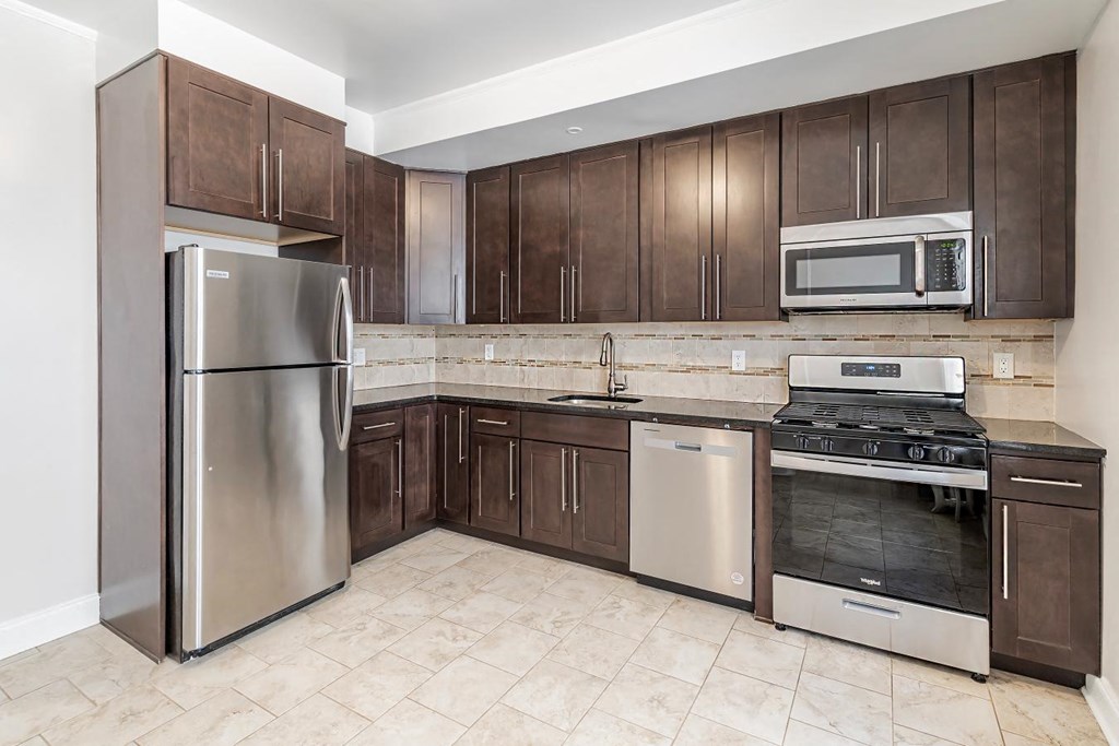 a kitchen with stainless steel appliances and wooden cabinets