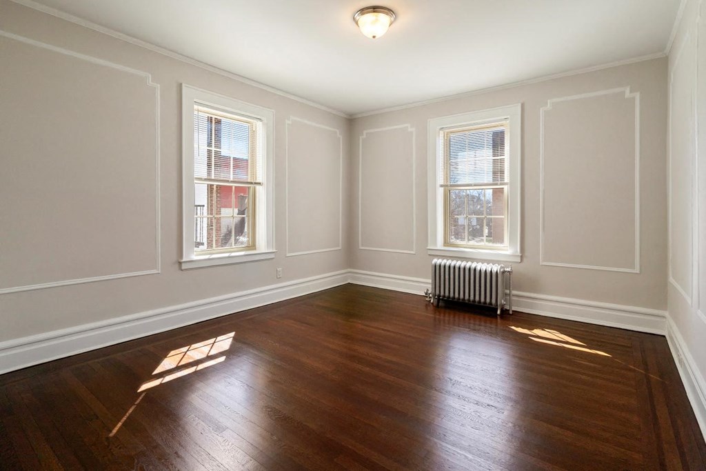 the living room of an empty house with wood floors