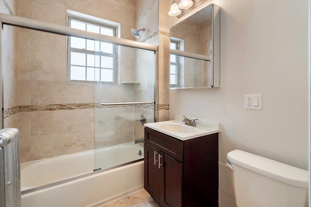 a bathroom with a sink toilet and a shower