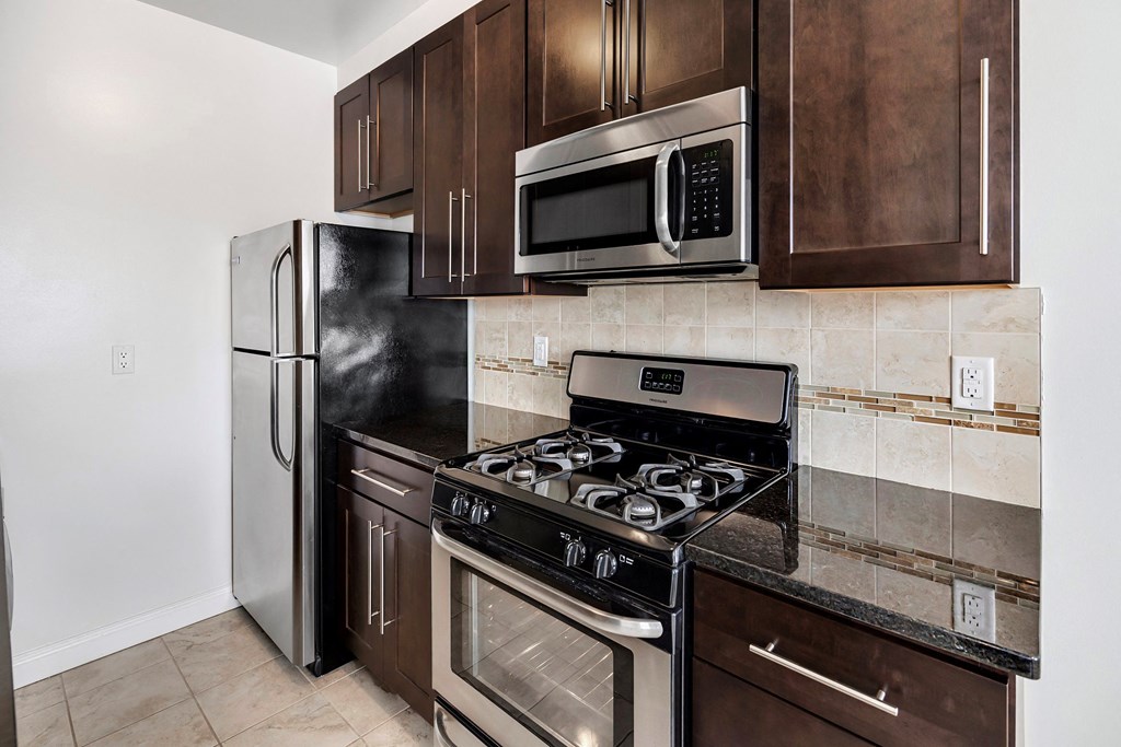 a kitchen with stainless steel appliances and wooden cabinets