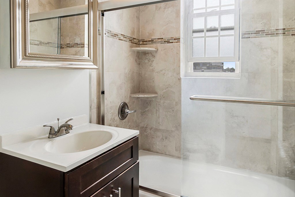 a small bathroom with a sink and a shower