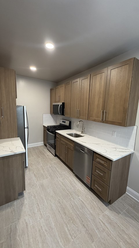 A kitchen with wooden cabinets and a white countertop.