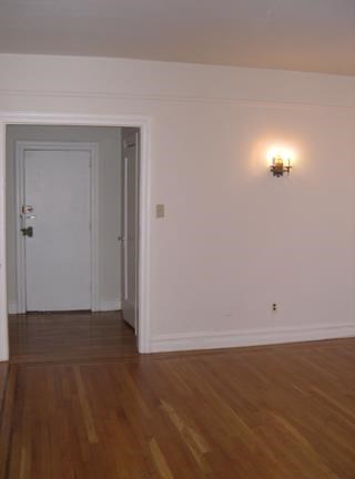 a empty room with a door and a light on the wall