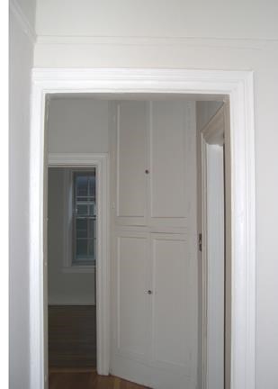 a white door in a room with a doorway