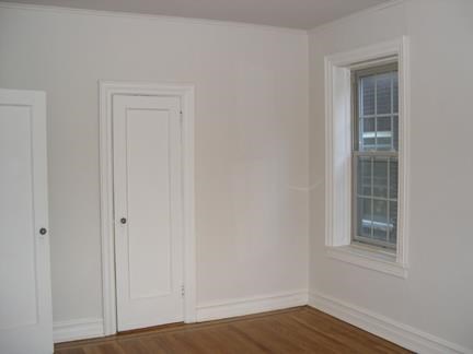 a empty room with a door and a window