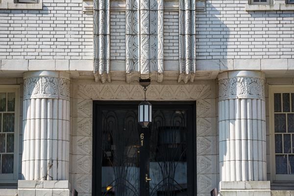 the front of a building with a black door