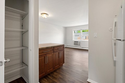 an empty kitchen and living room with an empty closet