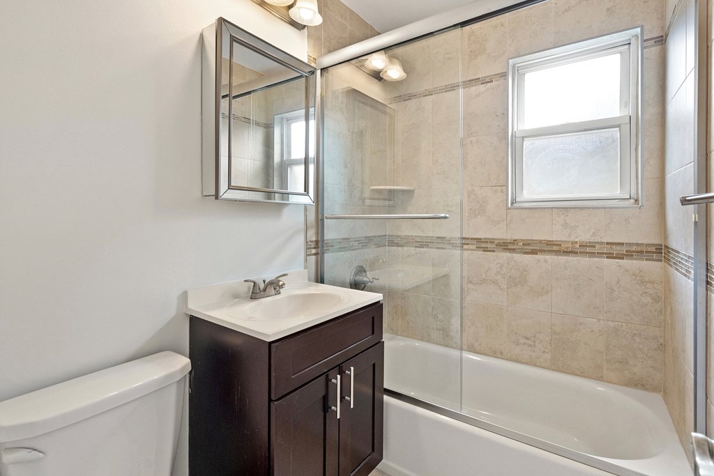 a bathroom with a shower and a sink and a mirror