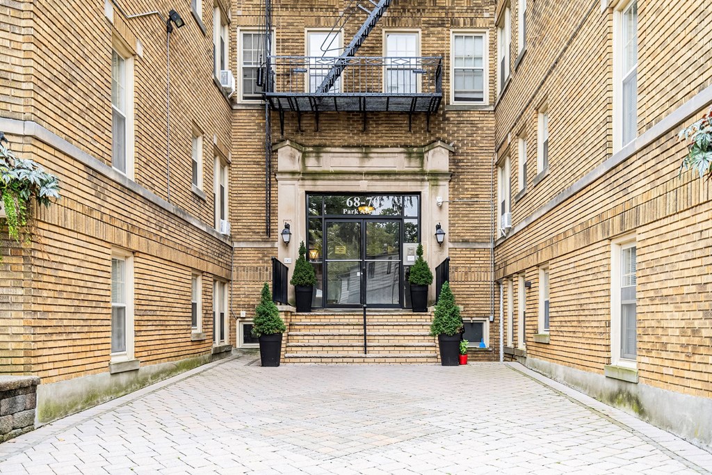 the entrance of a brick building with a glass door