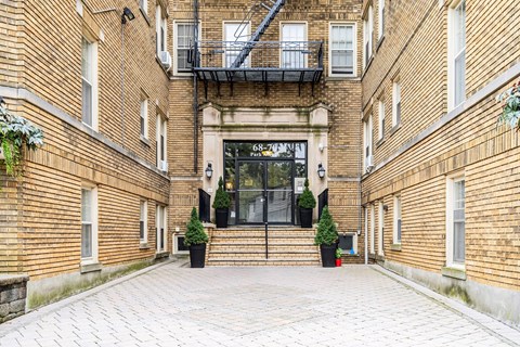 the entrance of a brick building with a glass door